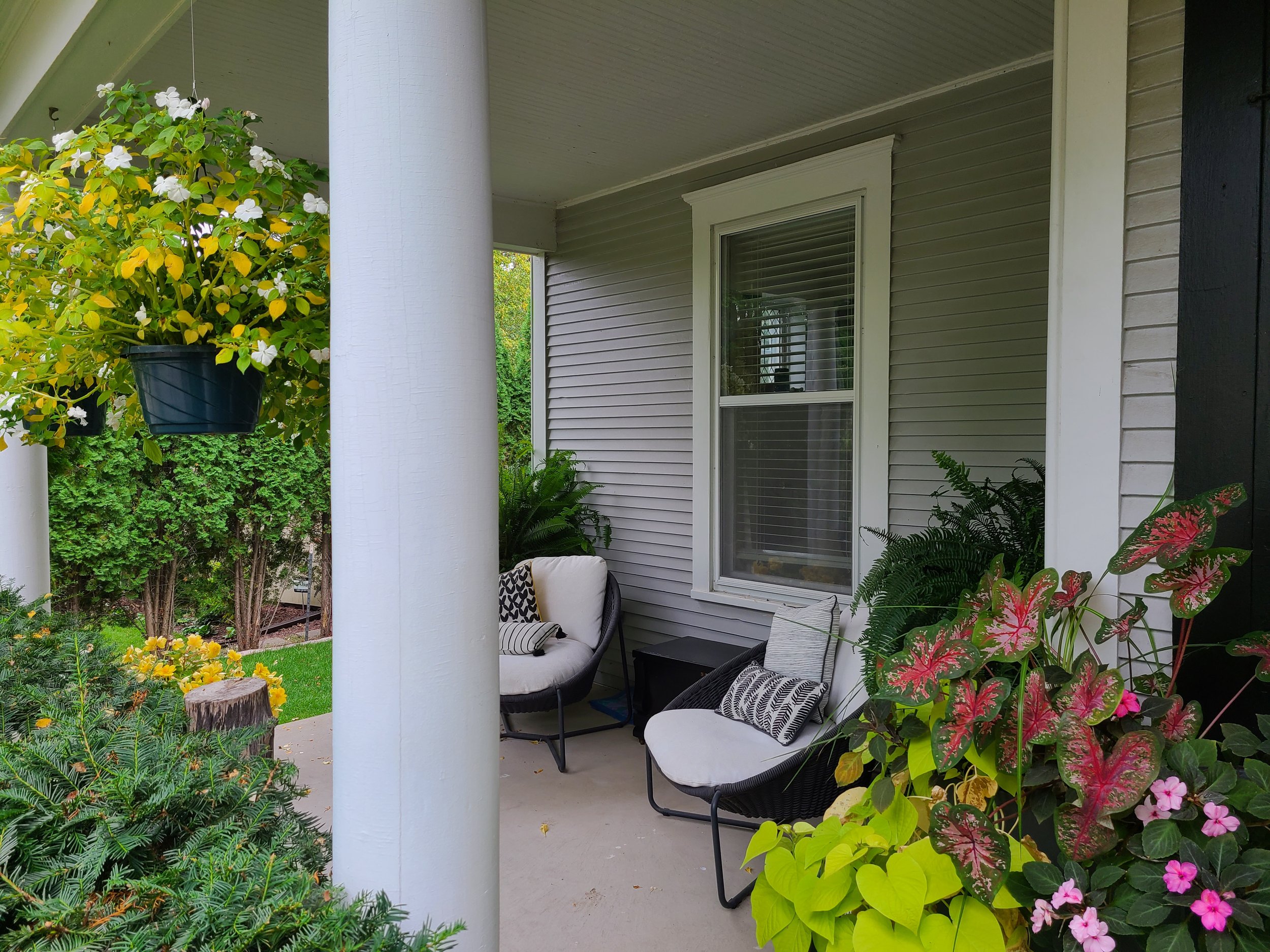 Freshly painted front porch of a Minnesota home with clean trim and inviting outdoor seating