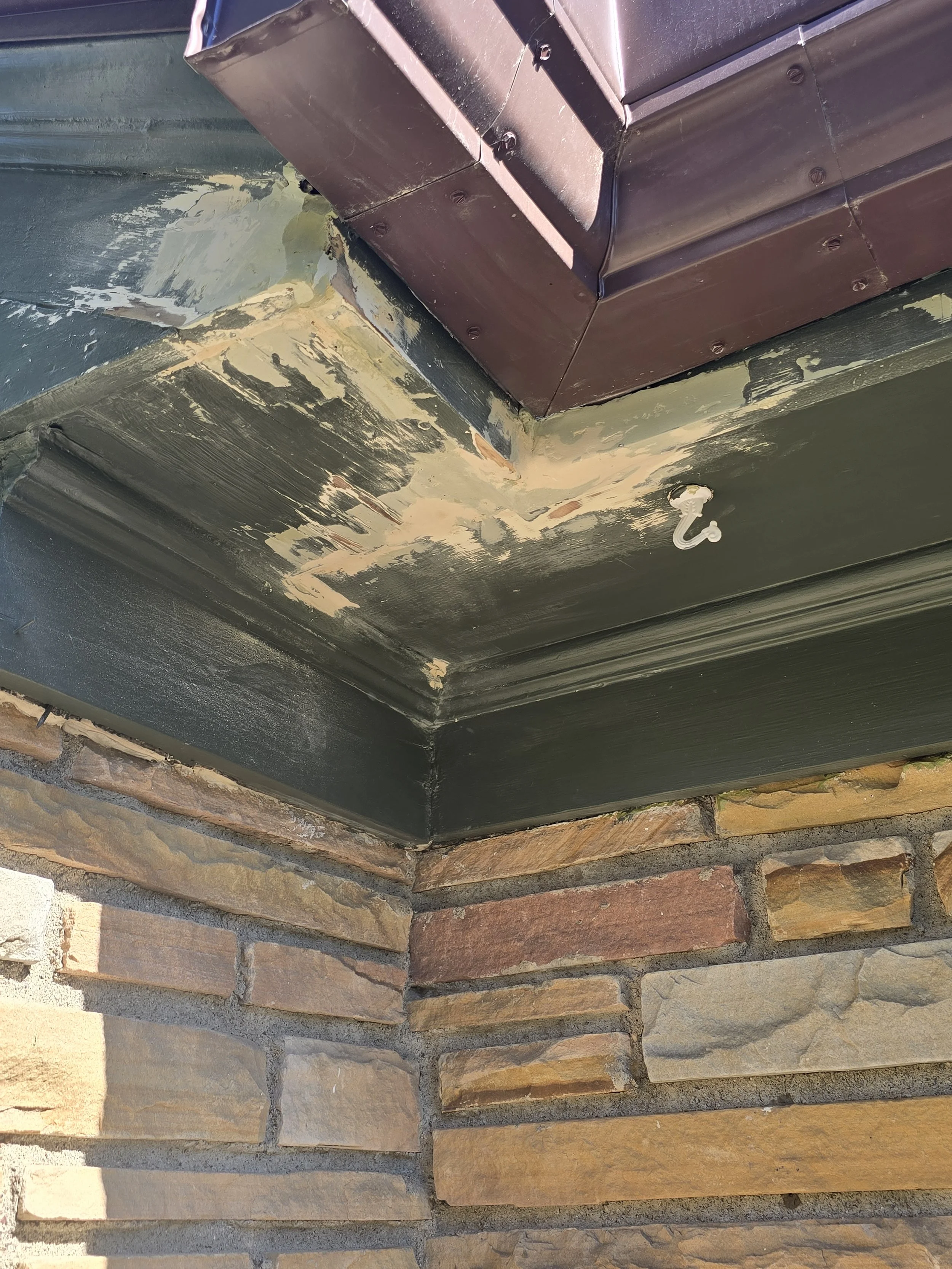 Detailed wood repair and shaping on a damaged eave in Northeast Minneapolis.