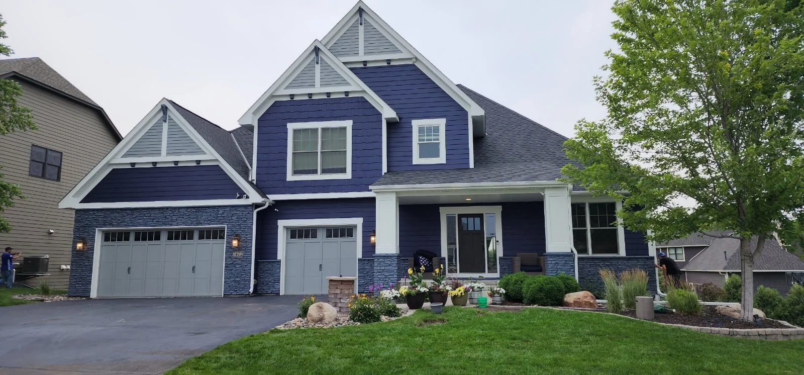 Modern exterior repaint on a deep blue home in Dayton, MN
