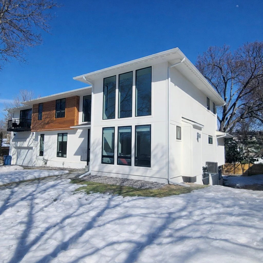 Modern white exterior house painting on contemporary Minneapolis home with large windows and cedar accents
