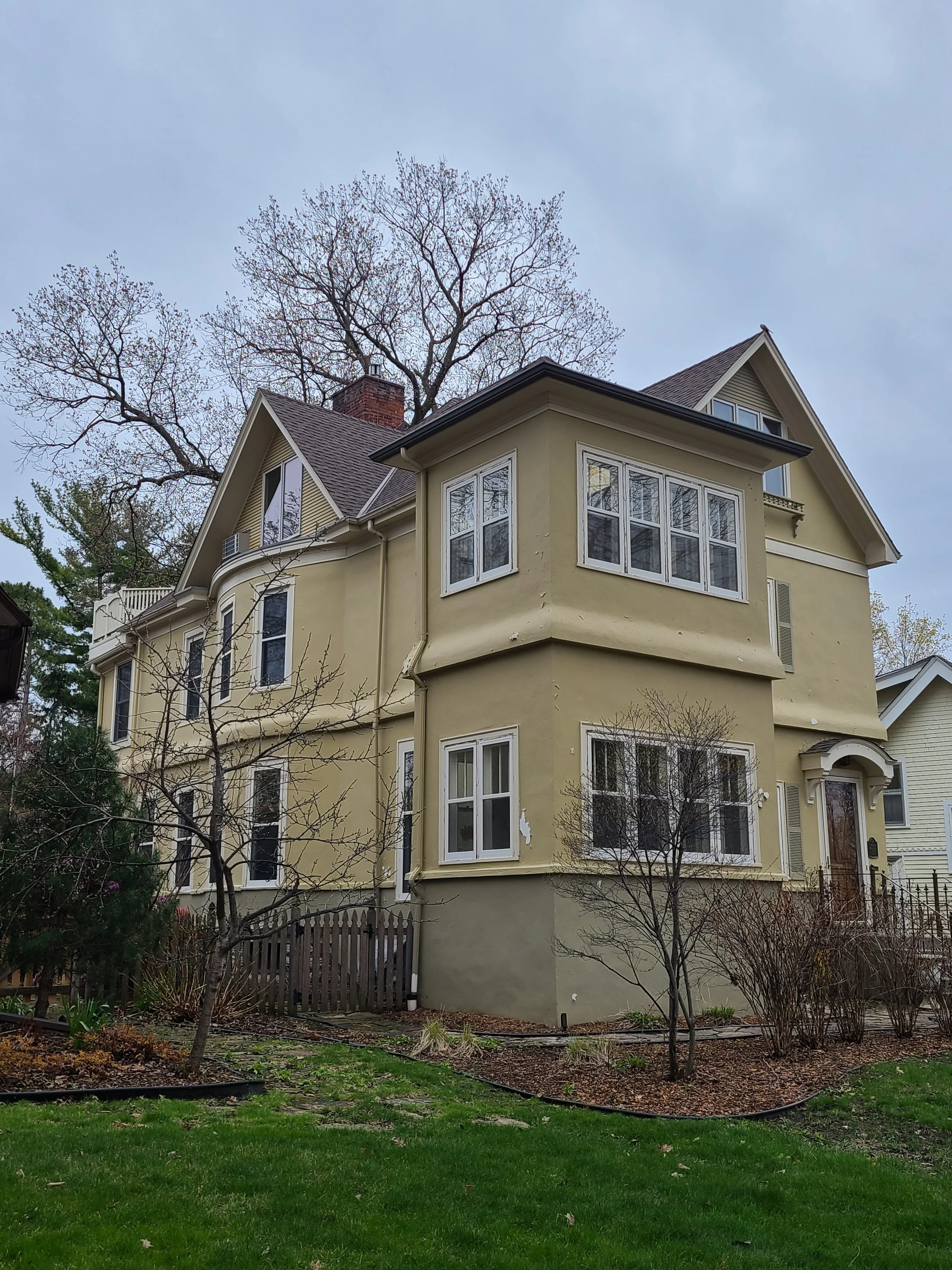 Before exterior painting of a Minneapolis stucco home prior to full repaint and restoration.
