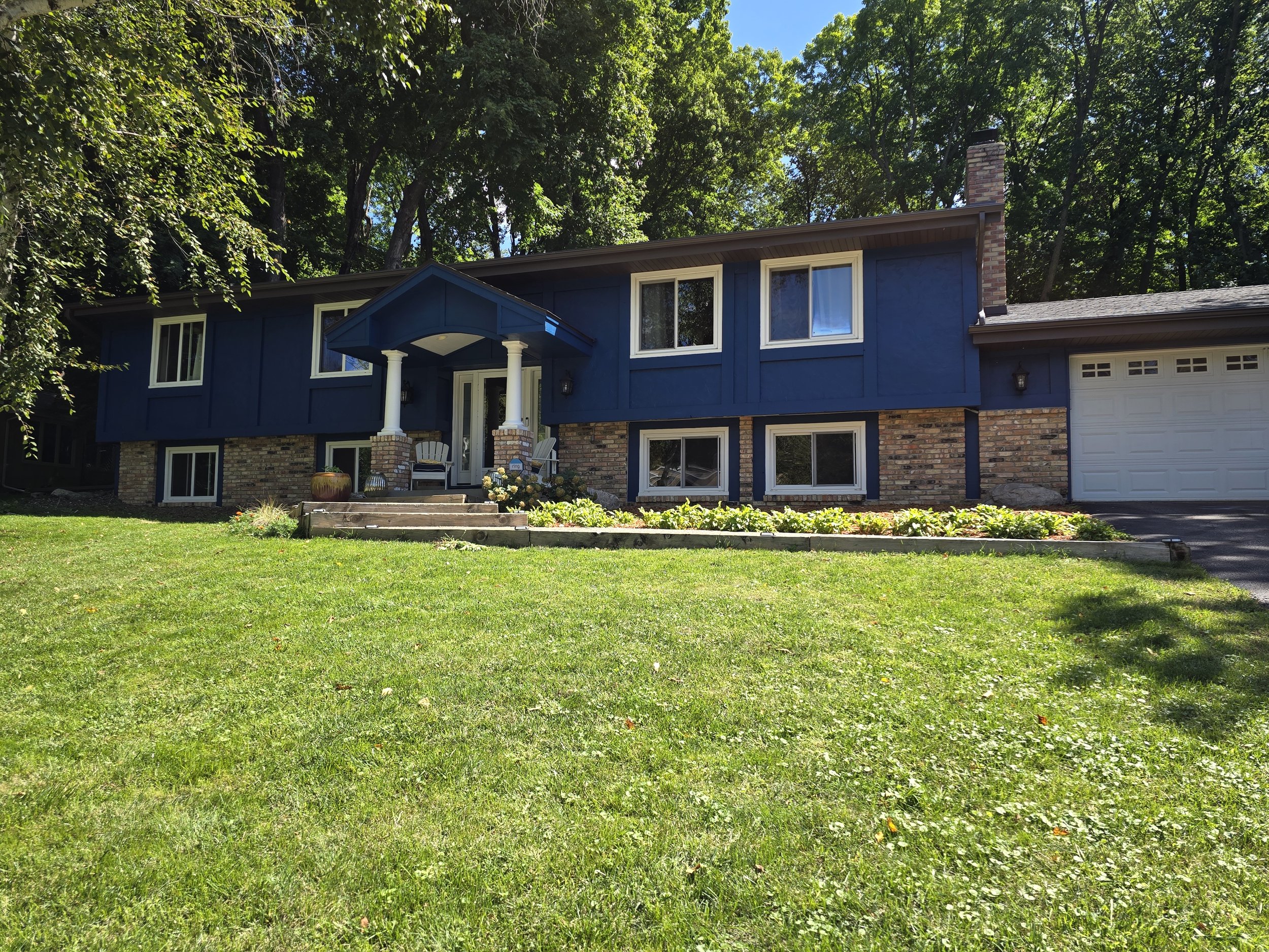 Two-story navy blue exterior house painting by Best House Painters in the Twin Cities
