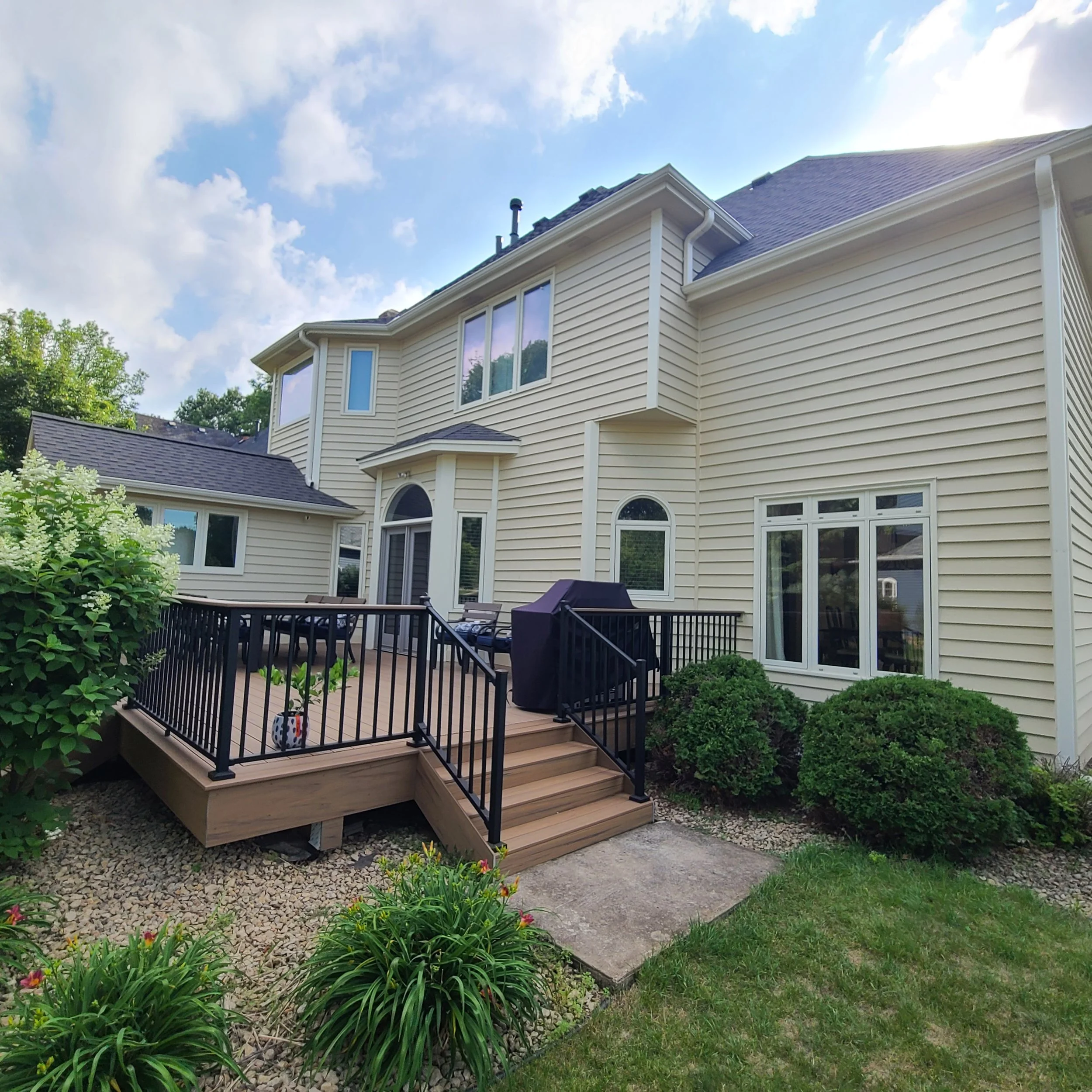 Rear exterior repaint with fresh siding and trim on a two-story Eagan home