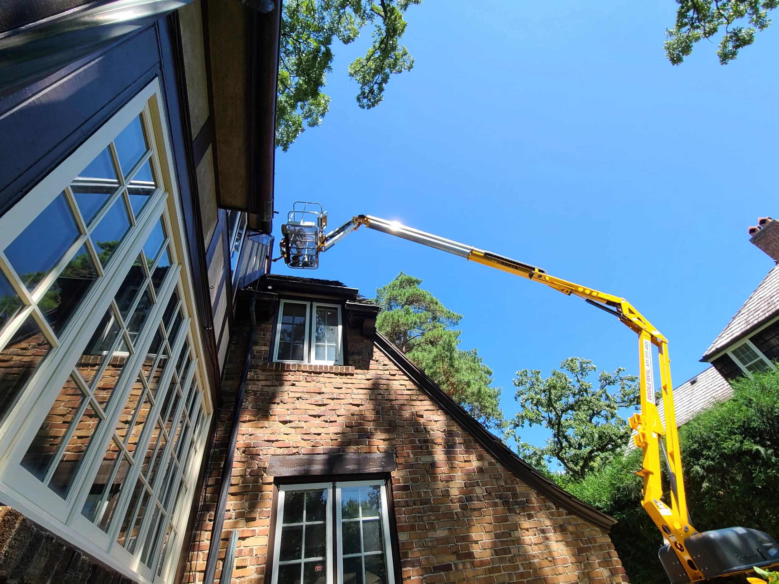 Professional exterior repaint on a parkway home near the Minnehaha corridor, completed with lift access for detailed restoration
