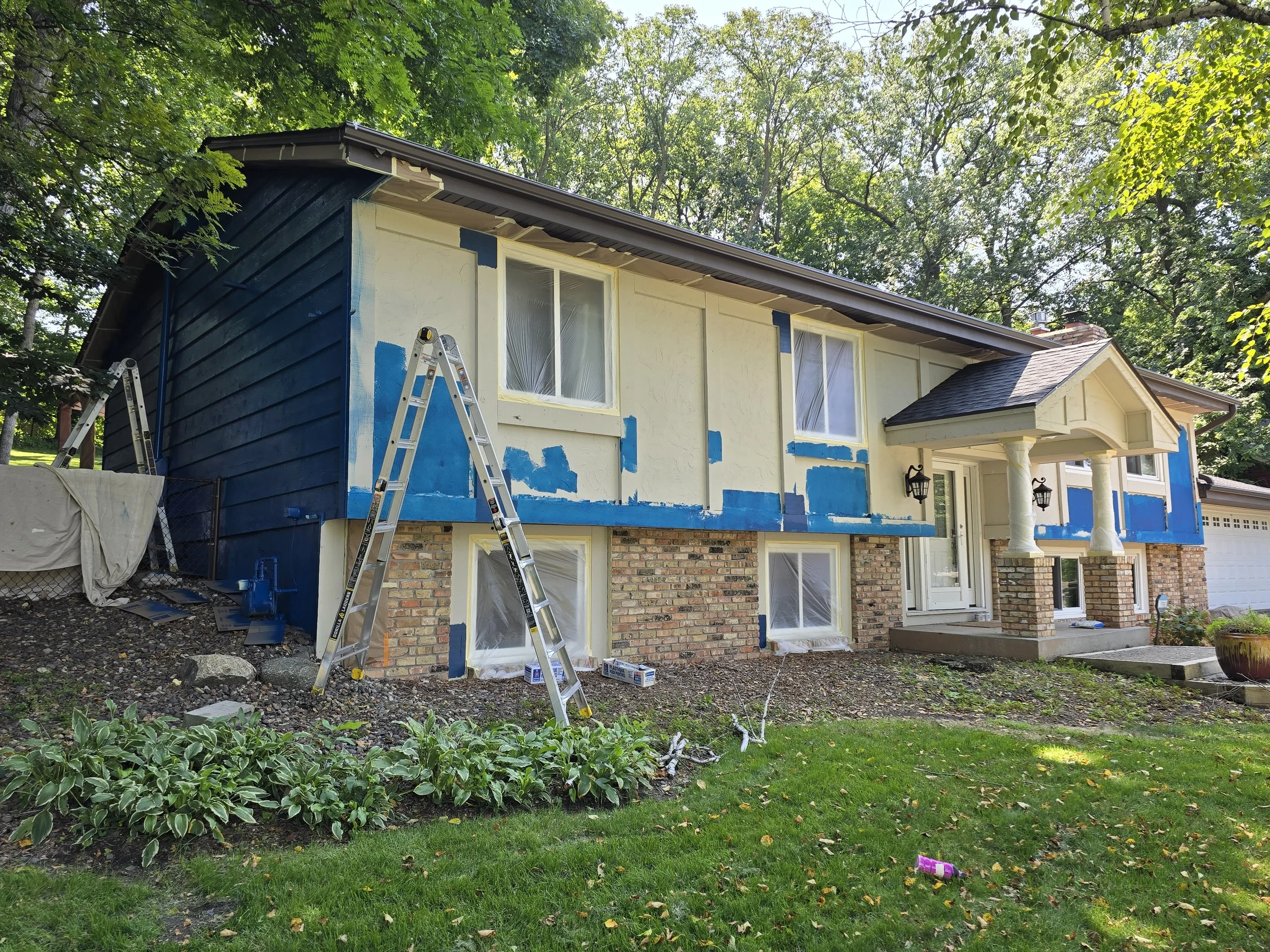 Tinted PrimeRx Peel Bonding Primer to stabilize faux stucco siding before two-coat finish on a bold exterior transformation.