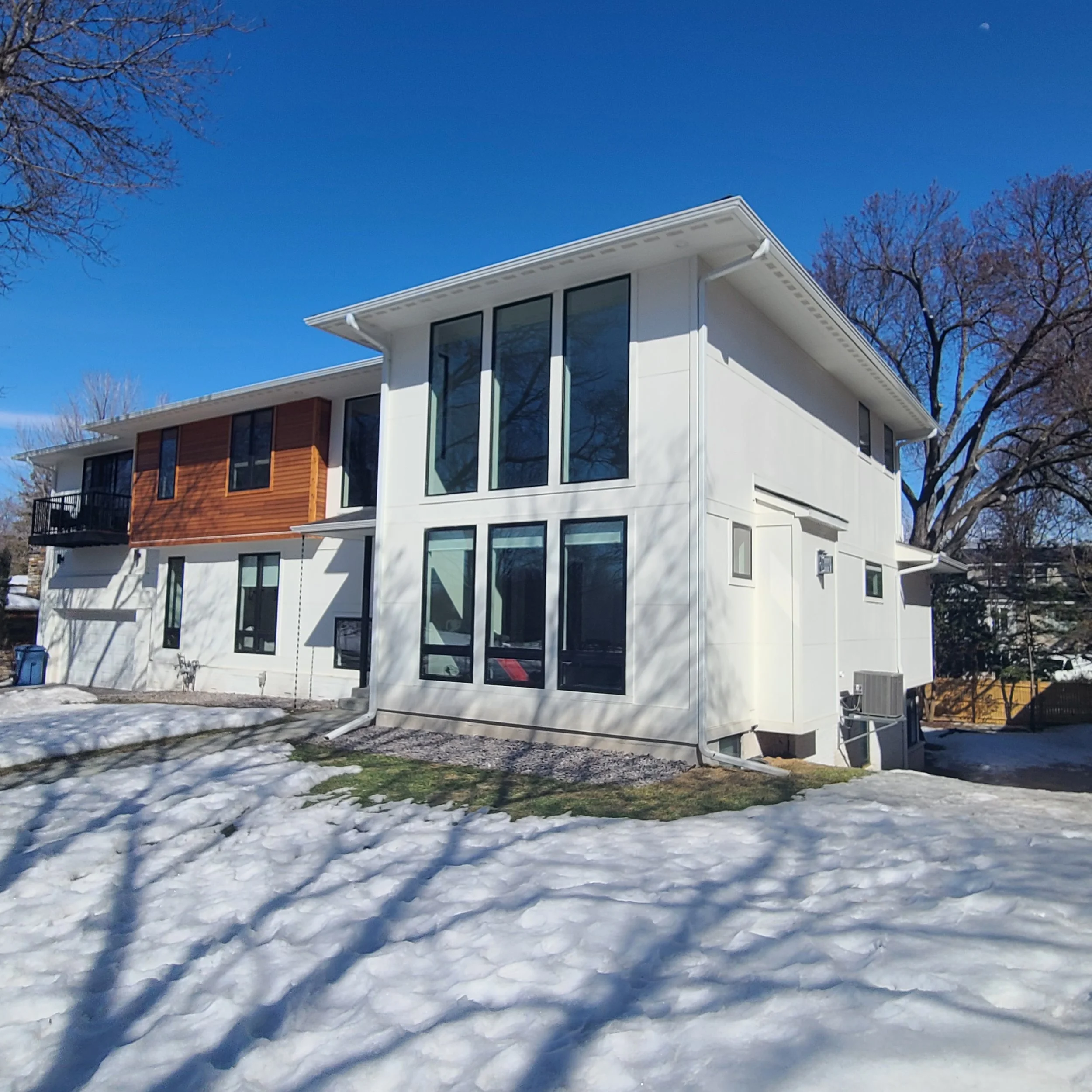 Modern white exterior house painting on contemporary Minneapolis home with large windows and cedar accents