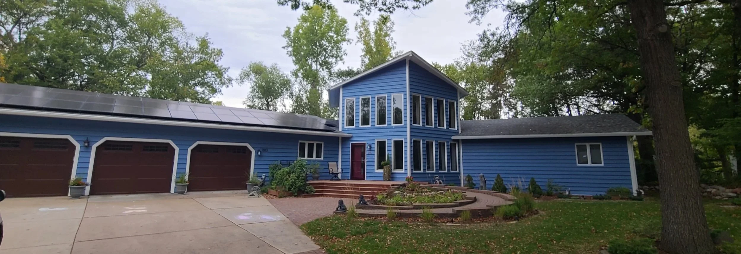 Fresh exterior repaint on a modern blue Twin Cities home with updated siding and trim