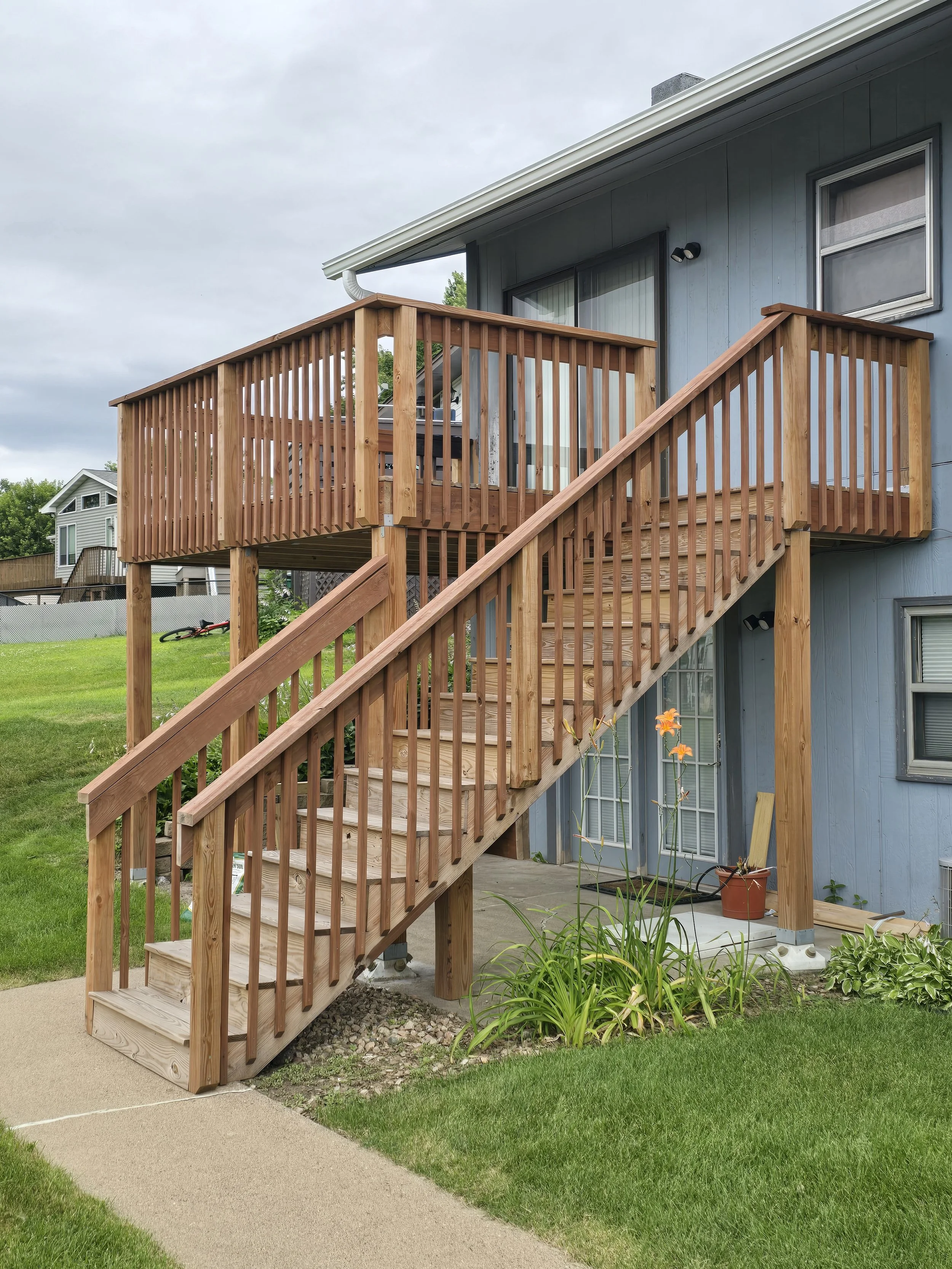 Aging association decks before prep and staining, showing sun-faded boards and worn finishes, which was the case for multiple units.