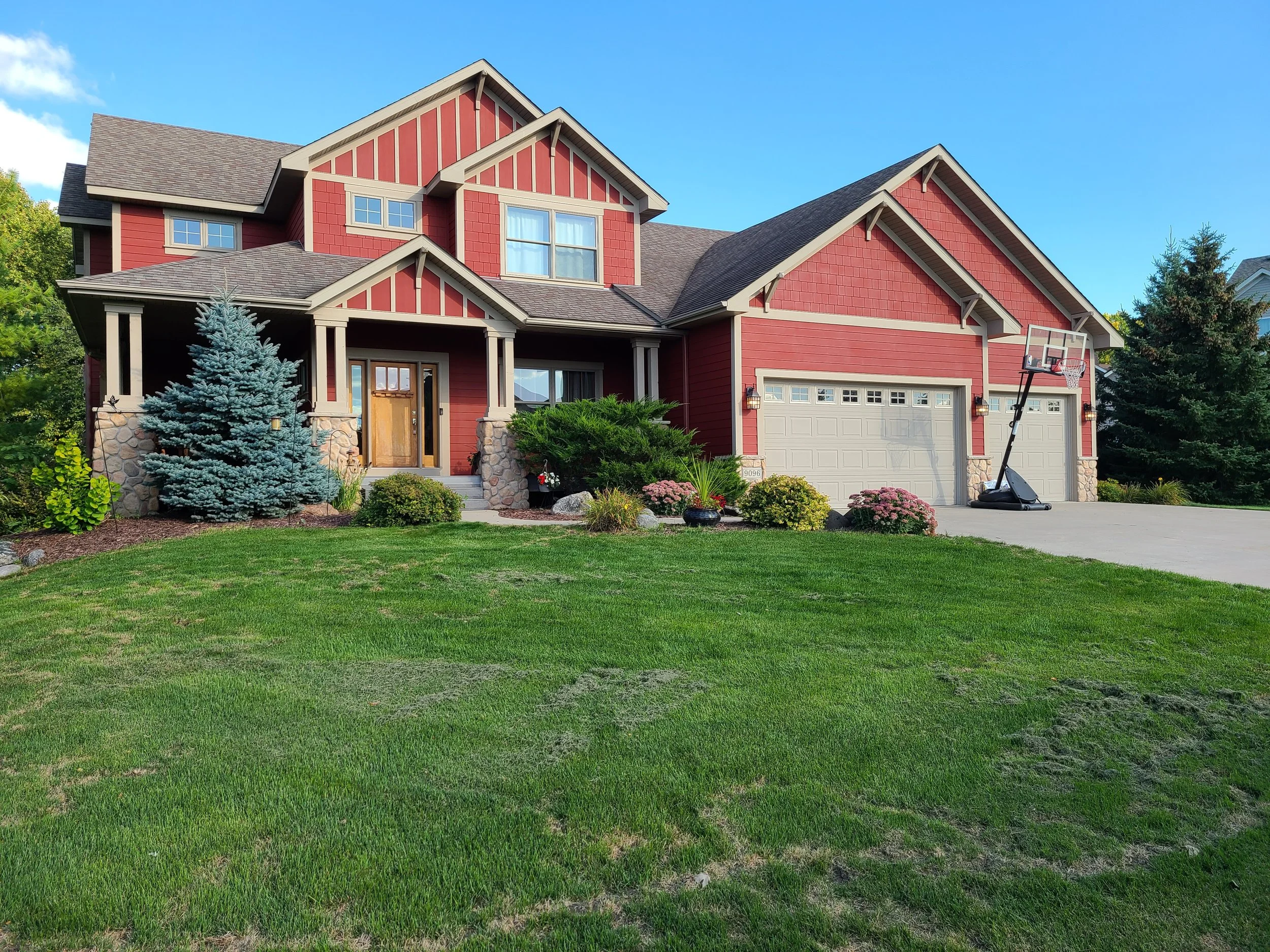 Striking red exterior transformation on a custom two-story home in Eagan, MN.