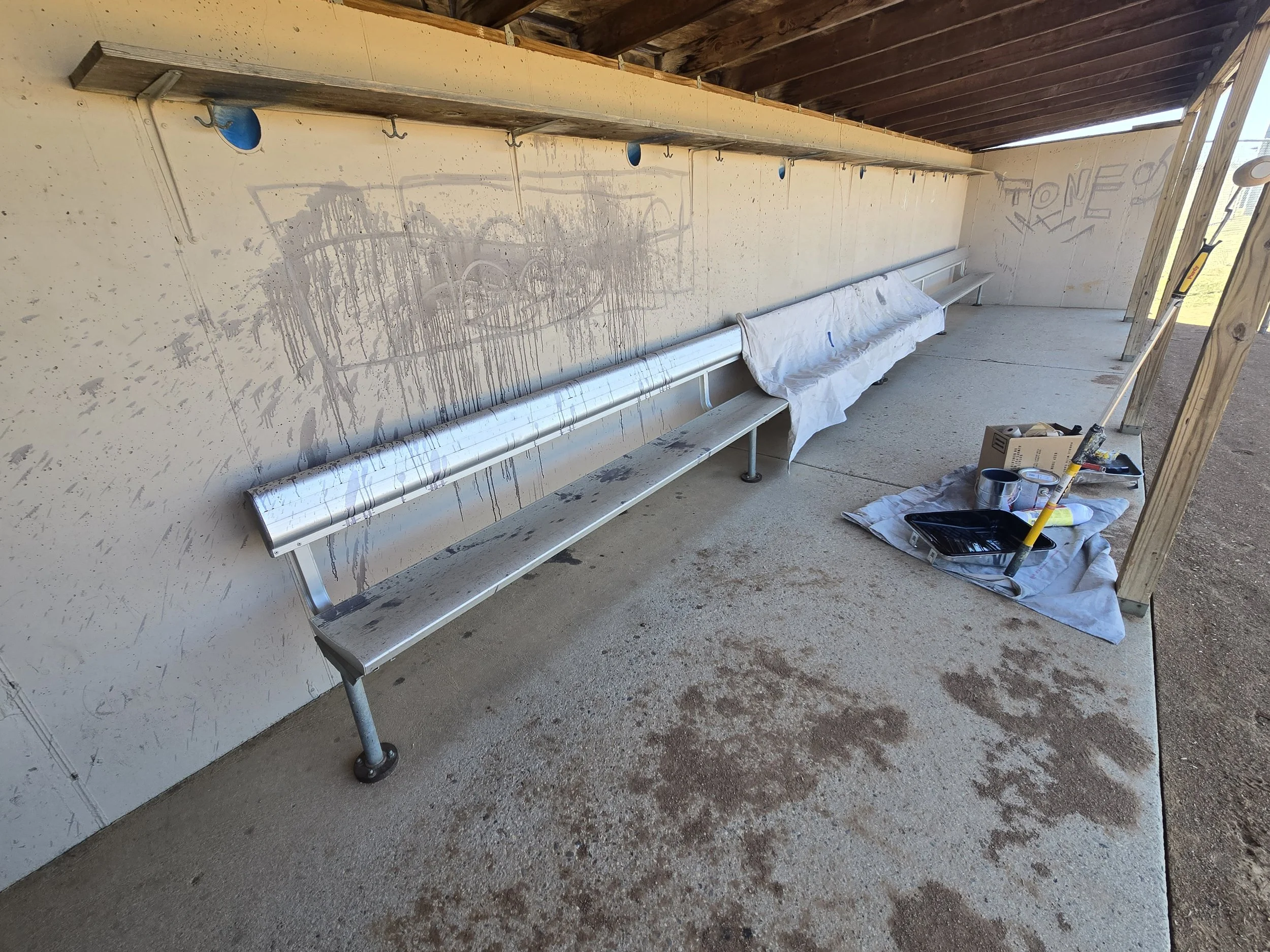 Well-used and graffitied baseball dugout before repainting at a neighborhood Minneapolis field.