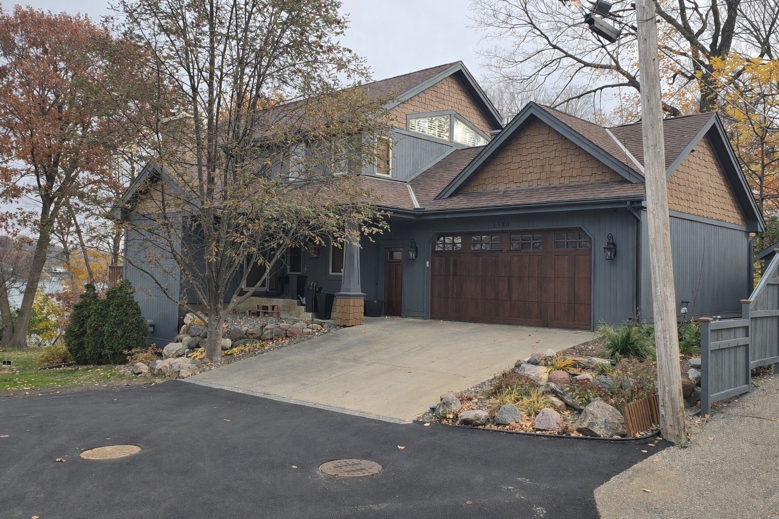 Mound, MN lakeside home refreshed with Sherwin-Williams WoodScapes solid stain for long-lasting color and protection.