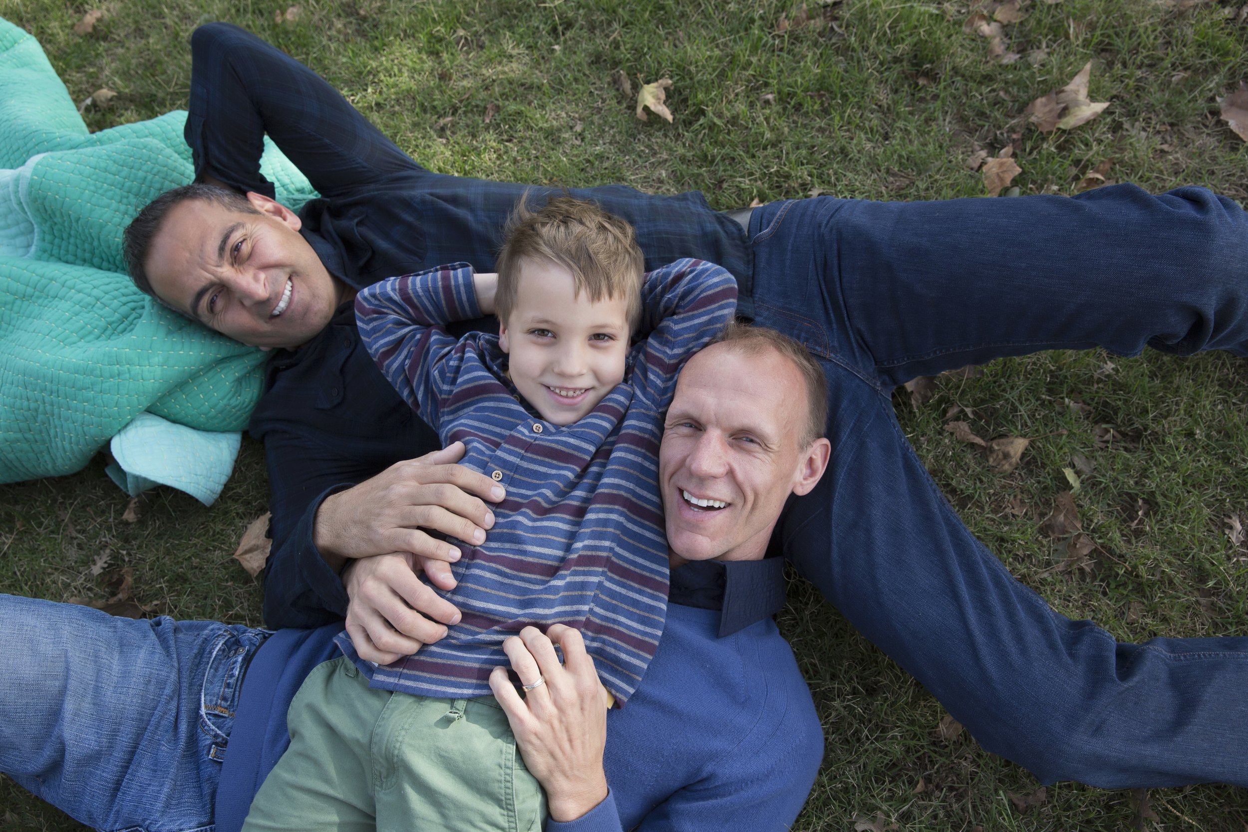 portrait-of-male-couple-and-son-lying-on-backs-in-2025-04-03-22-21-26-utc.jpg