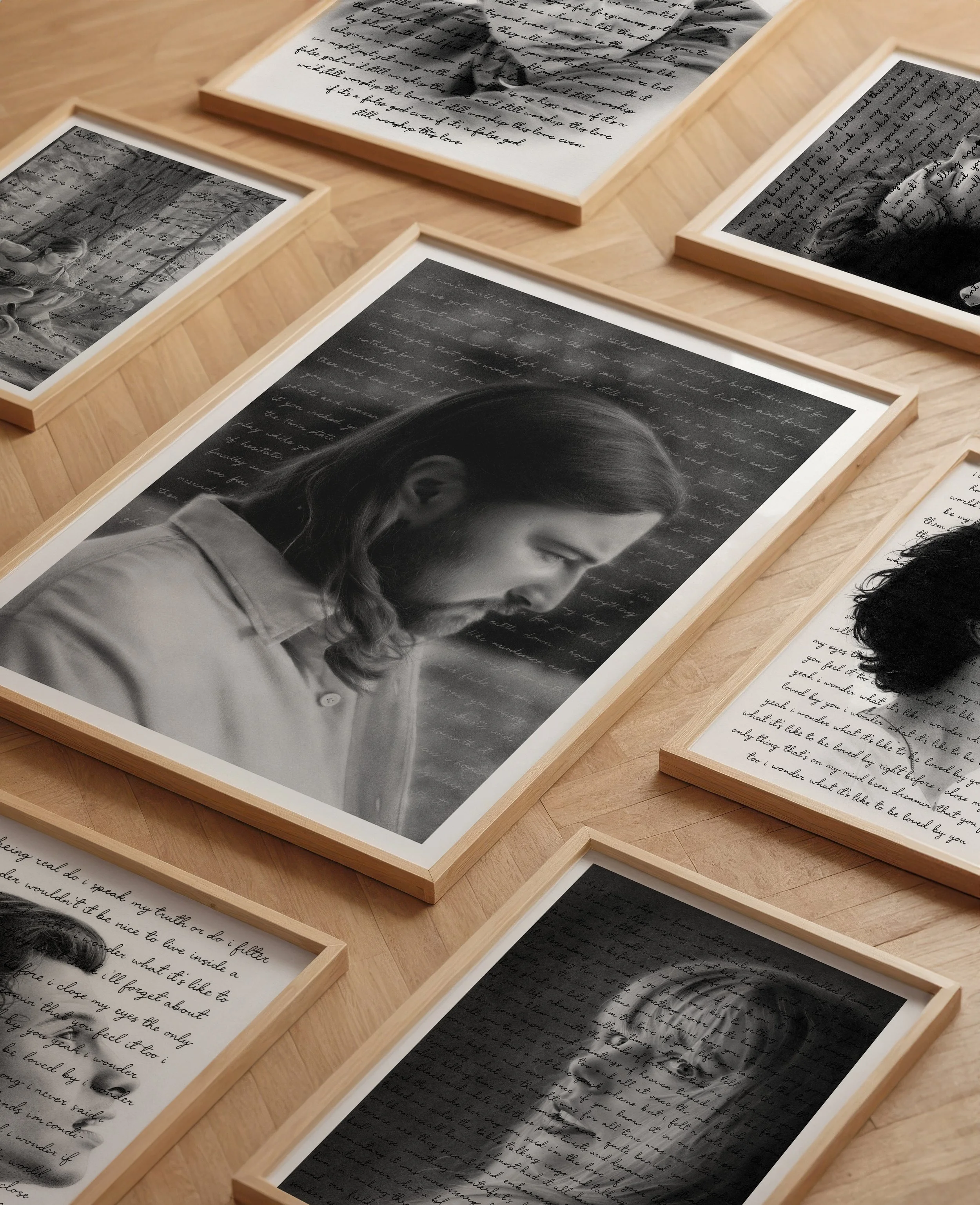 Multiple framed black and white photographs and handwritten letters or notes arranged on a wooden surface. The photos include a woman with closed eyes and handwritten text in the background.