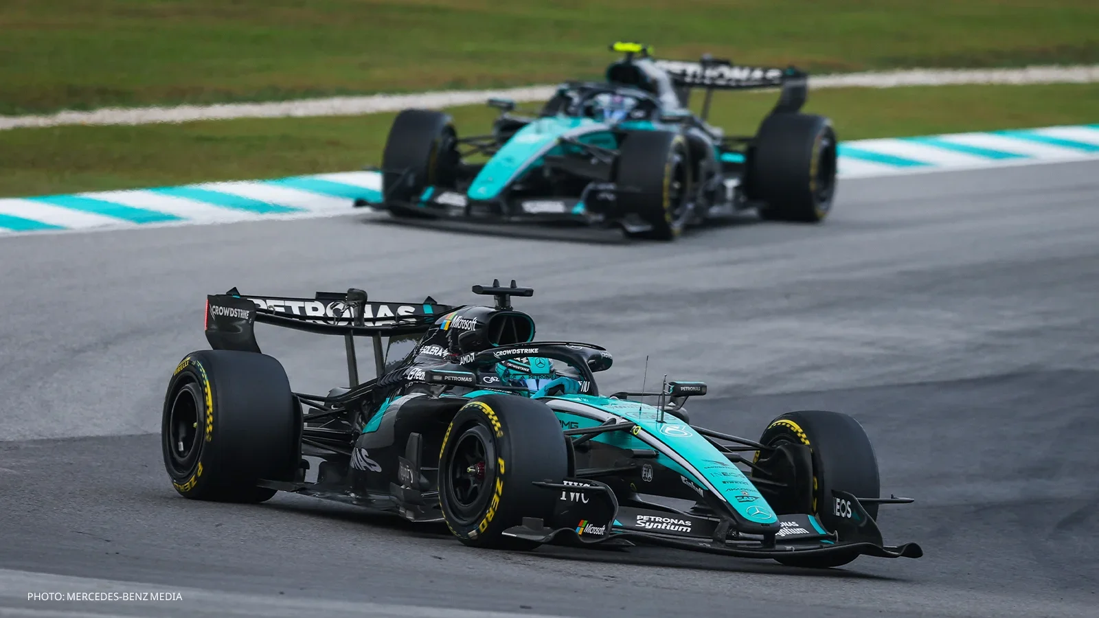 George Russell driving his Mercedes, with the second Mercedes following behind on track.