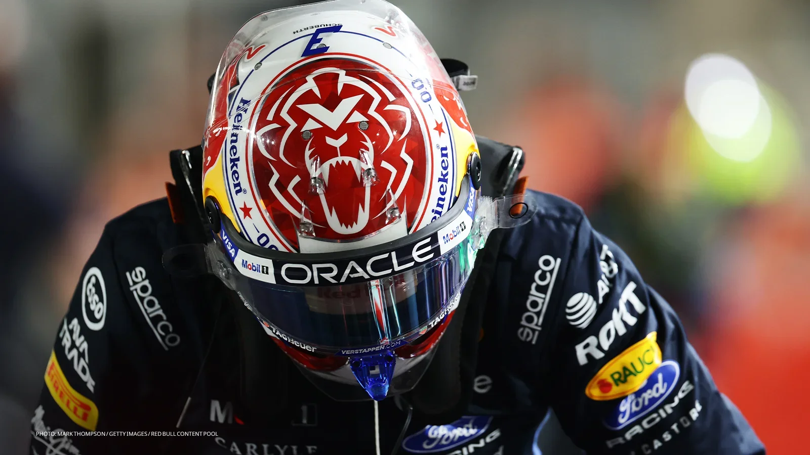 Max Verstappen wearing his helmet and Red Bull race suit in parc fermé during Singapore Sprint qualifying.
