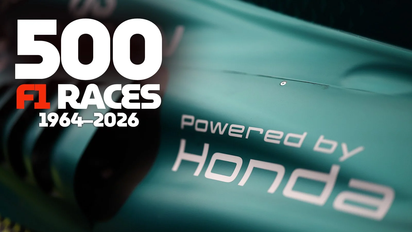 Close-up of an Aston Martin Formula 1 car with Powered by Honda branding and a graphic marking Honda’s 500 F1 races from 1964 to 2026.