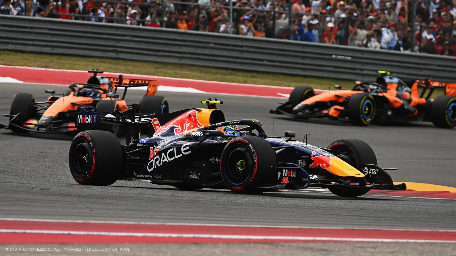 Isack Hadjar’s Red Bull leads the McLarens of Oscar Piastri and Lando Norris through a corner at the United States GP.