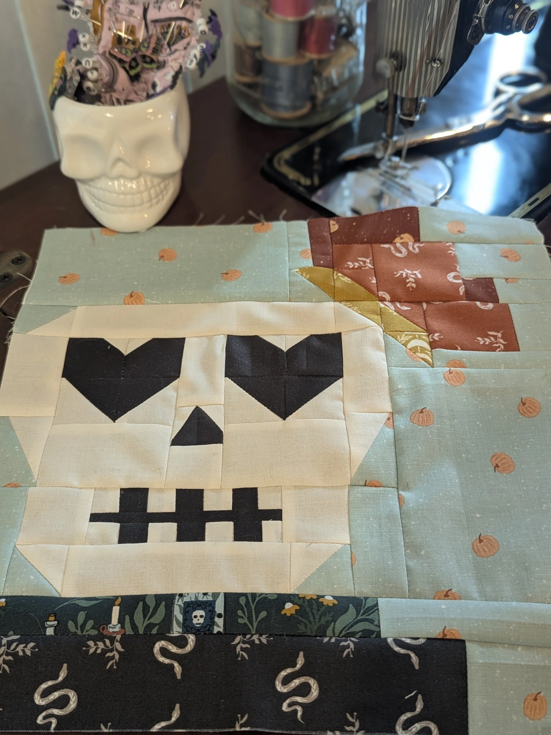 Skull quilt block on sewing table