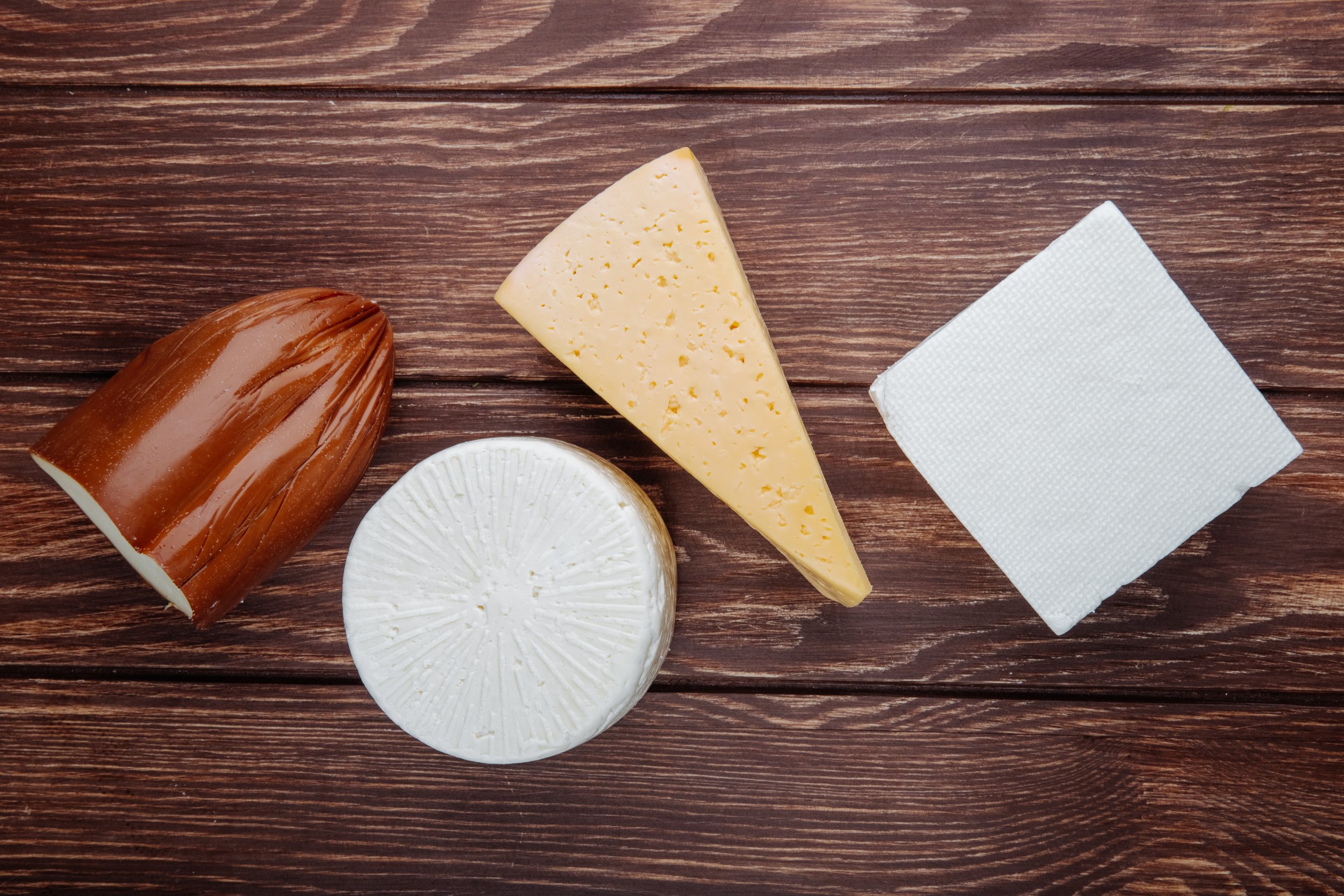 top-view-different-kind-cheese-rustic-wooden-table.jpg