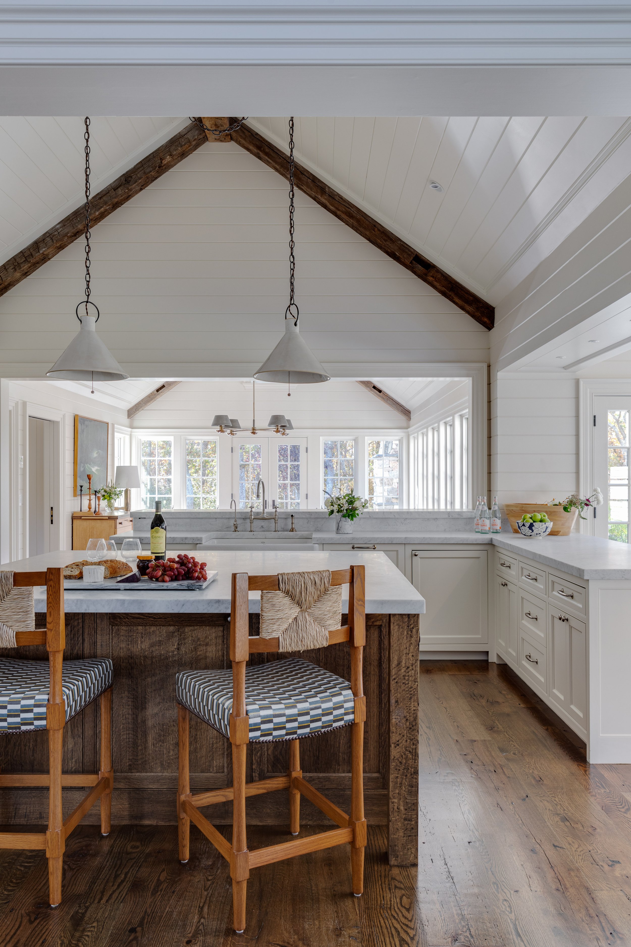 Kitchen interior by Good Bones Design with warm wood, bright light and blue accents