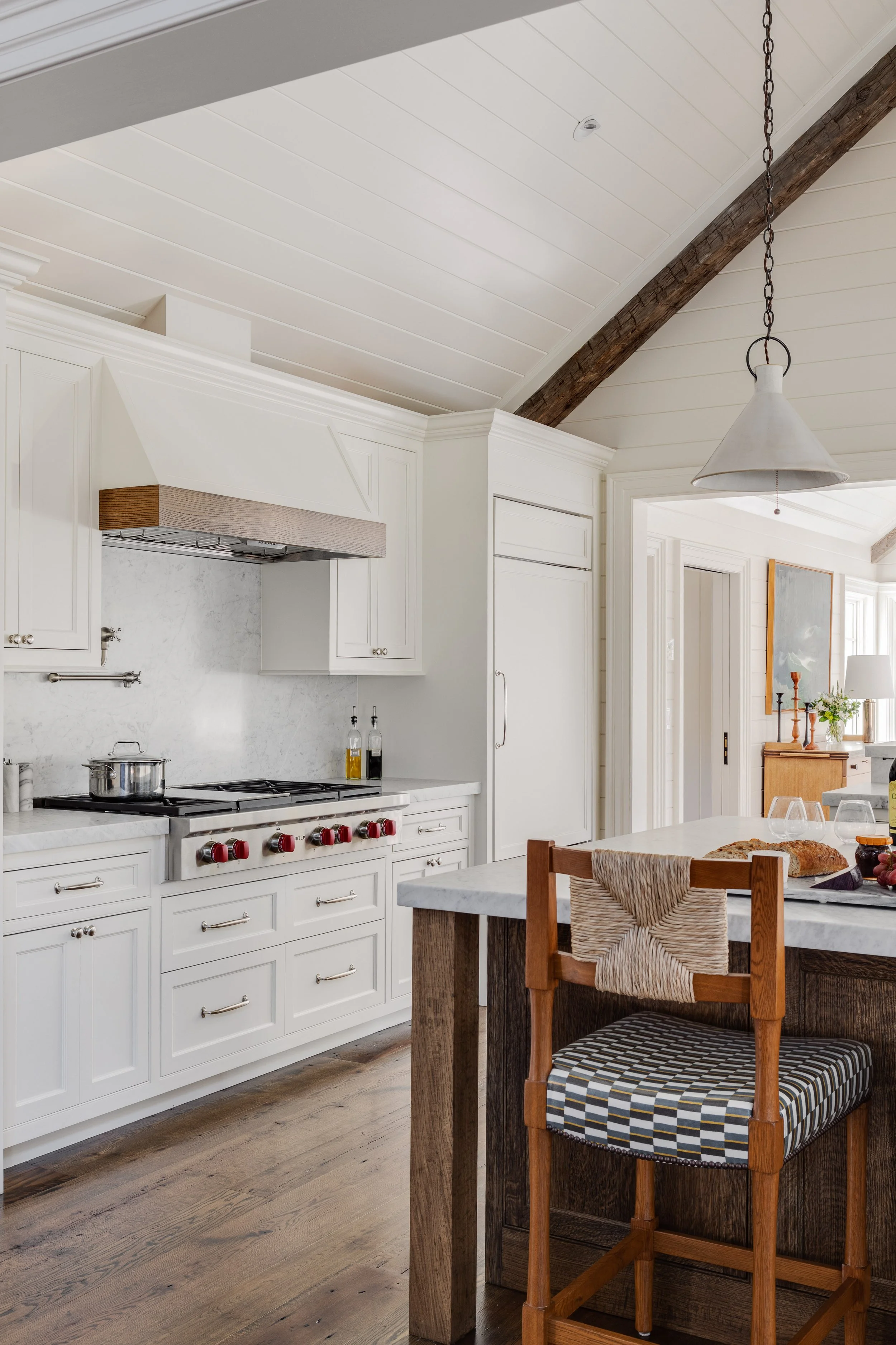 Kitchen interior by Good Bones Design with warm wood, bright light and blue accents