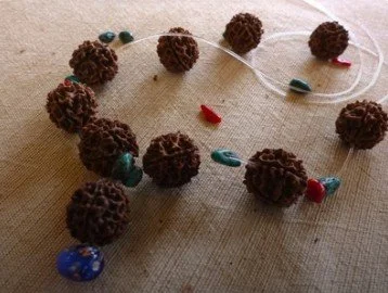 A work in progress rudraksha seed mala necklace.