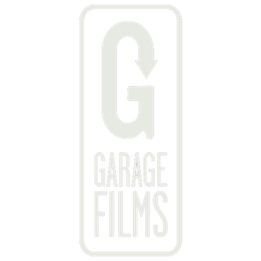 Garage Films logo with a large letter 'G' and an arrow pointing downward, enclosed in a black rectangular background.music composition, music composer, sound design, audio mixing, audio master, voice over recording