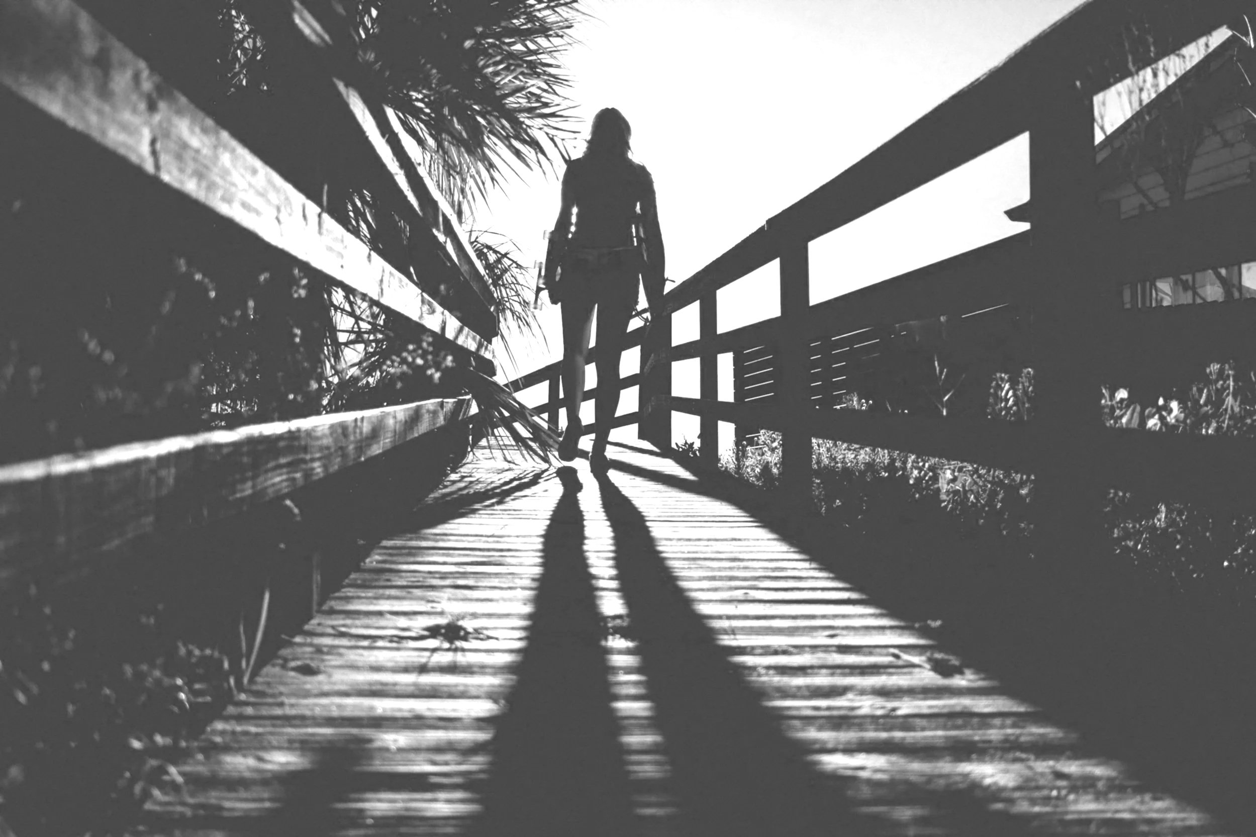woman walking up bridge