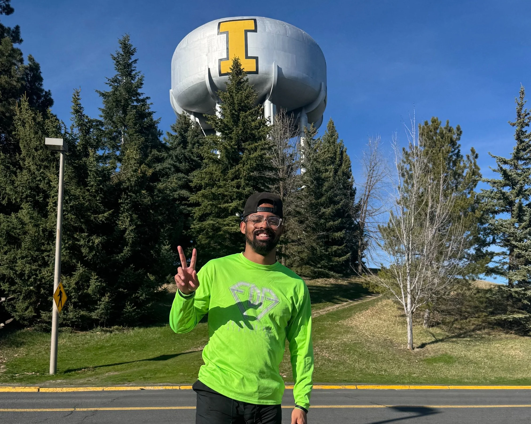 A smiling man in front of an Idaho water tower.