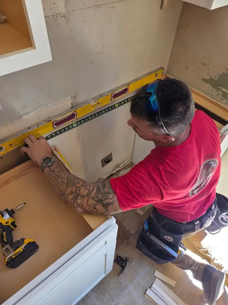 David Bowler Construction contractor leveling kitchen cabinets in Redding