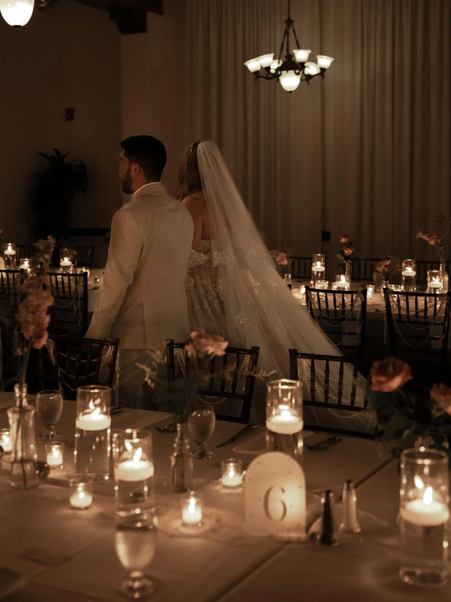 The wedding of Courtney &amp; Patrick at @casamarinahotel 🖤. What a romantic atmosphere from start to finish, featuring stunning florals, &amp; the lovely long tables filled with candles. Courtney was the definition of a princess bride in her custom