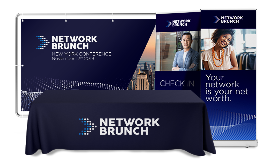 Branded event booth with banners and table cover for a professional creative service at the Network Brunch conference.
