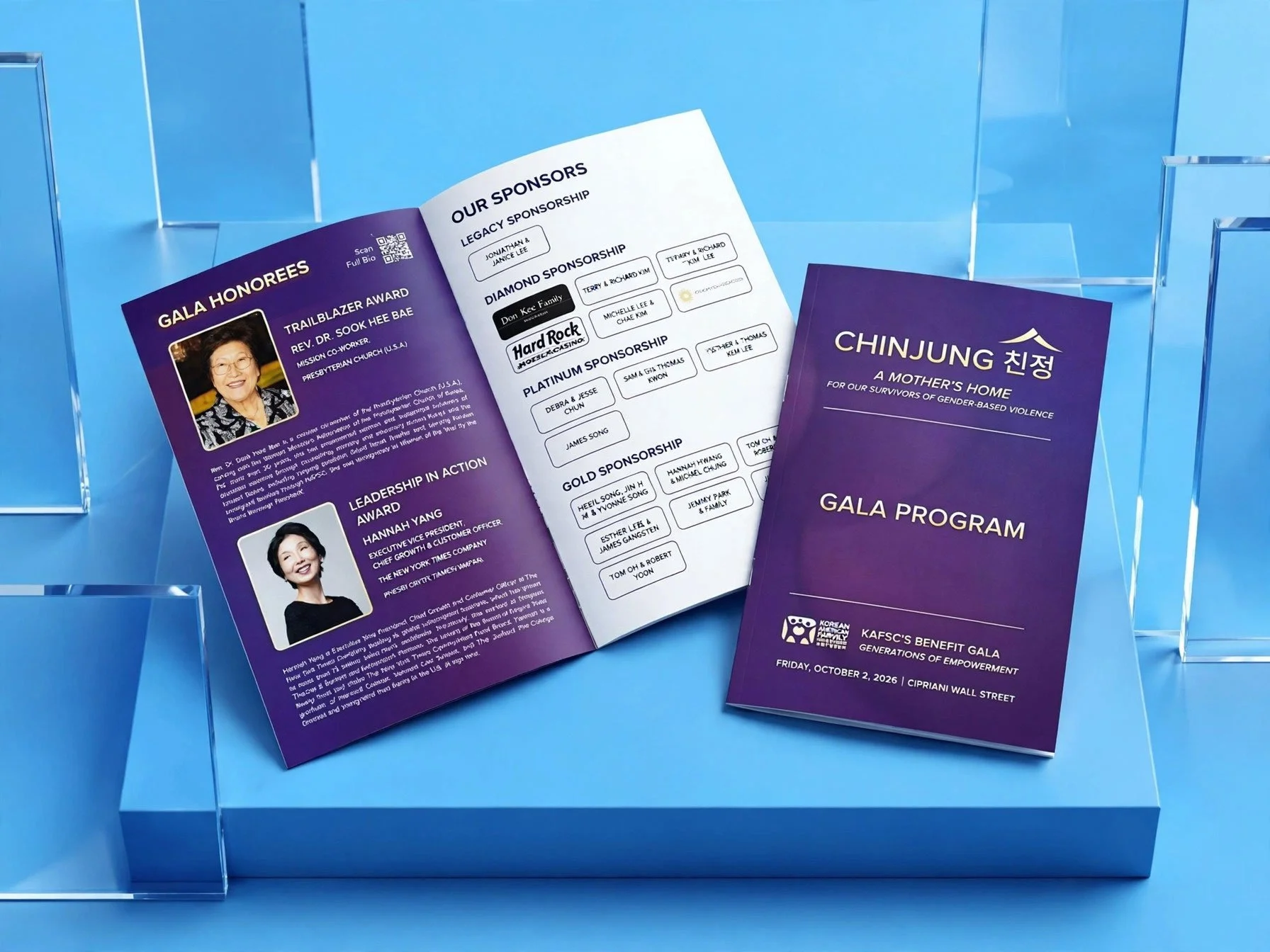A professionally displayed KAFSC Gala Program brochure opened to reveal sponsor lists and honorees on a blue pedestal background.