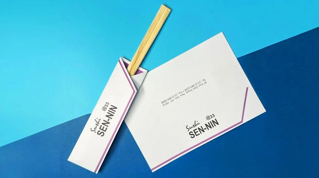 Professional Sushi Senin, custom chopsticks cover and branded stationery set displayed on a sleek blue background.