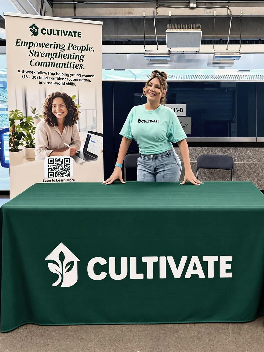 Milagros Carbajal, branding for the Cultivate fellowship, showcases promotional materials at a community event booth.