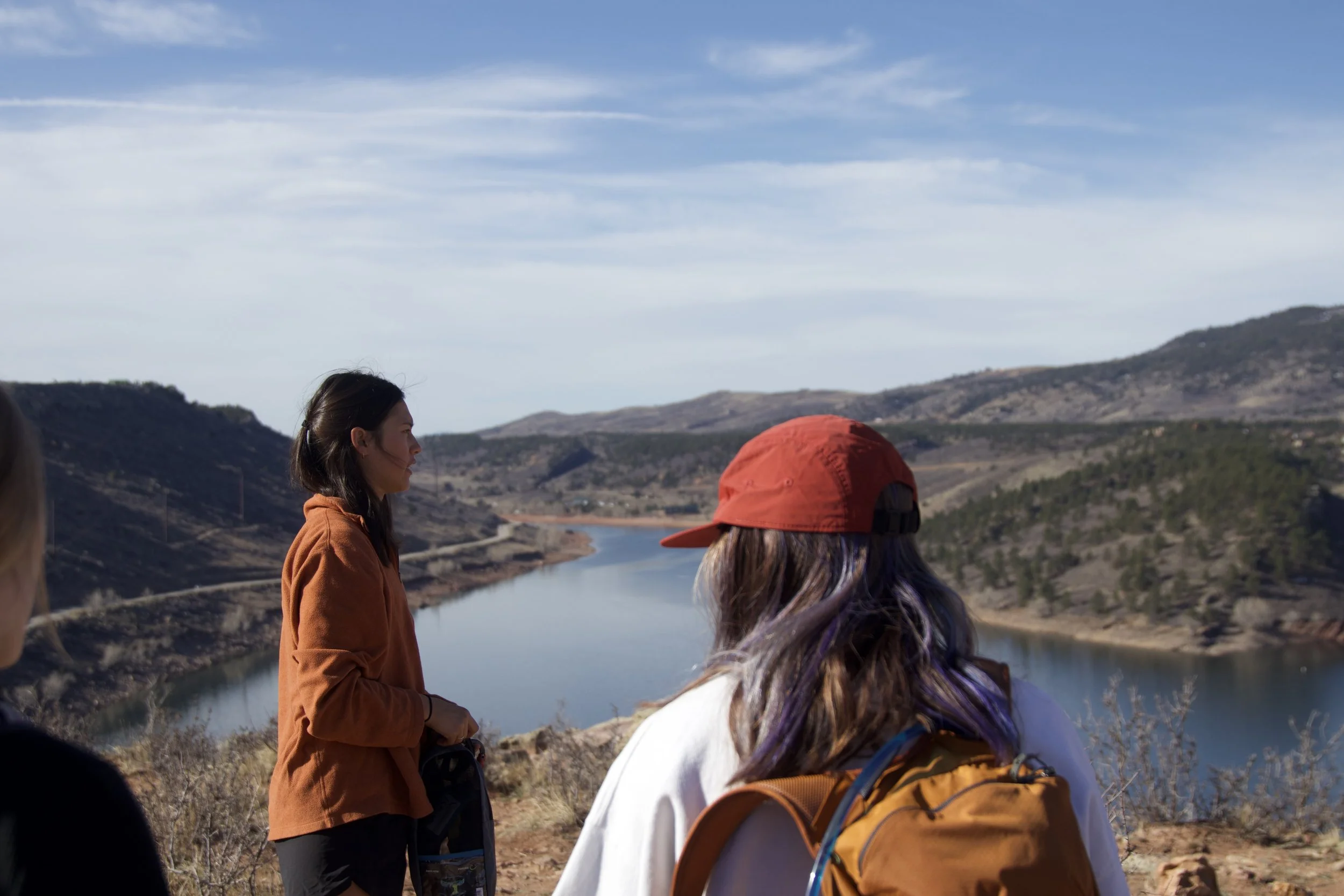 "Nature's Mirror"
People hiking near a lake with mountains in the distance