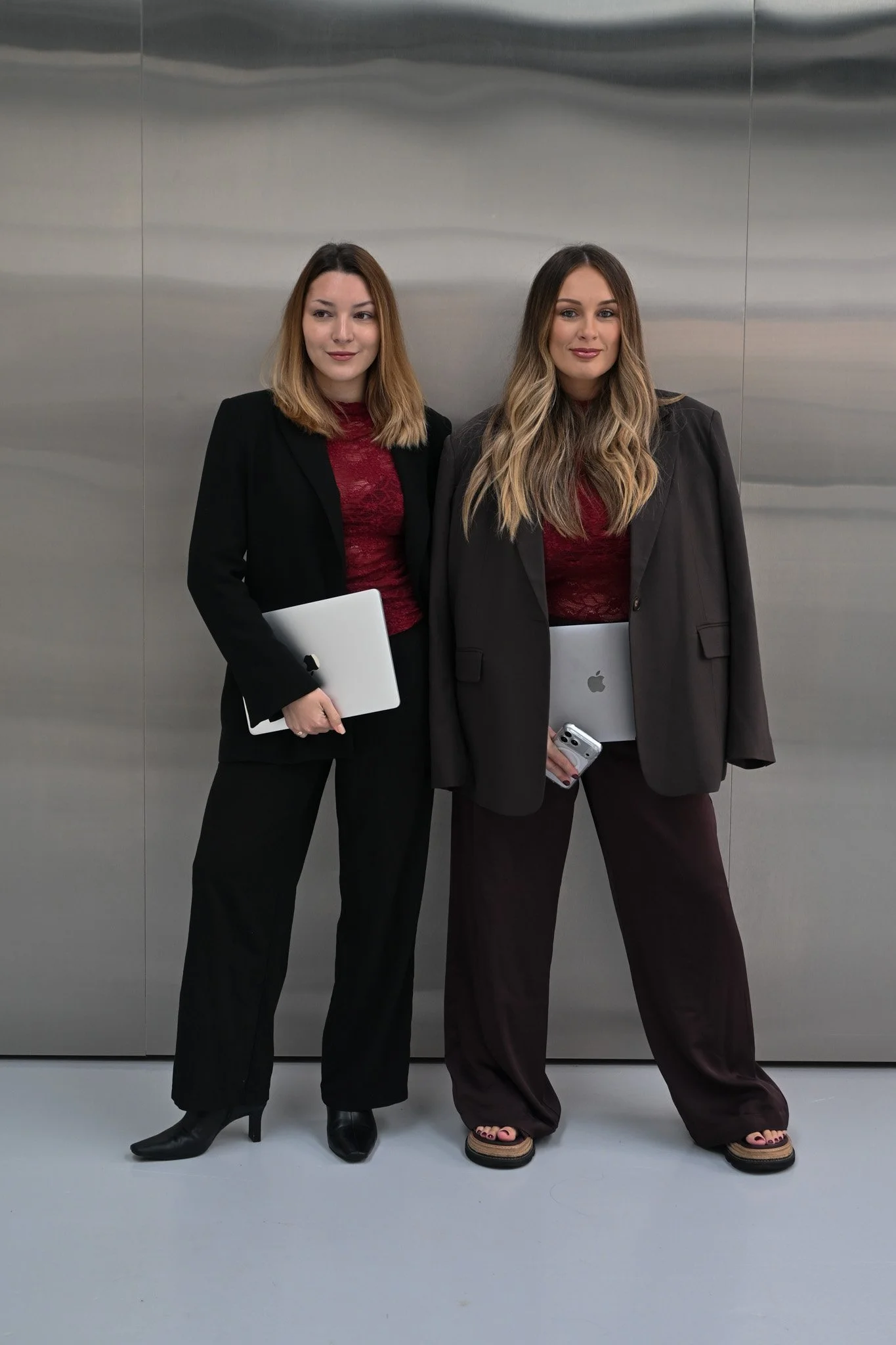 Kult Society team holding laptops.