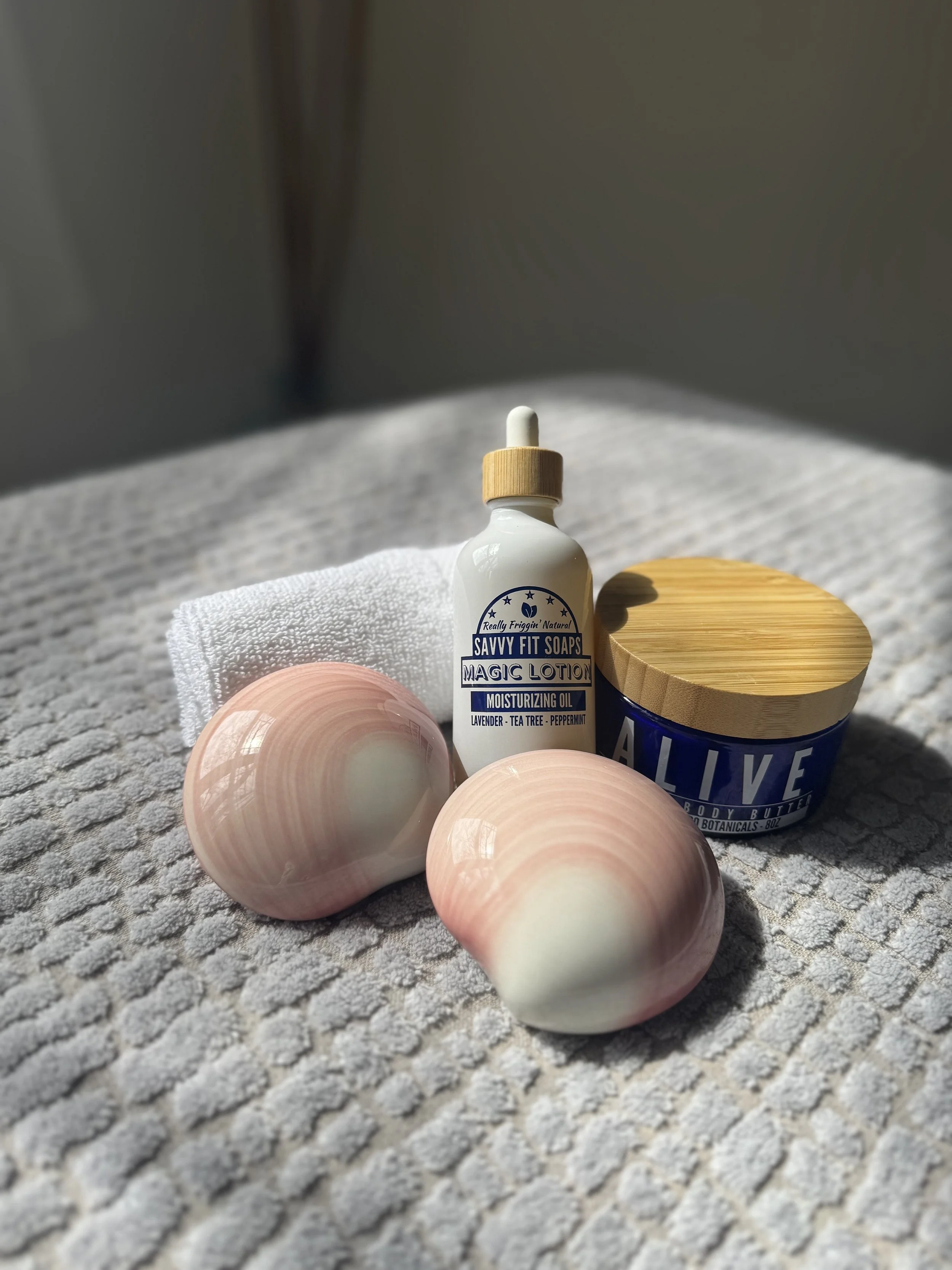 Image of ThermaBliss lava shells, Savvy Fit Soaps Magic Lotion and Alive Body Butter with a washcloth