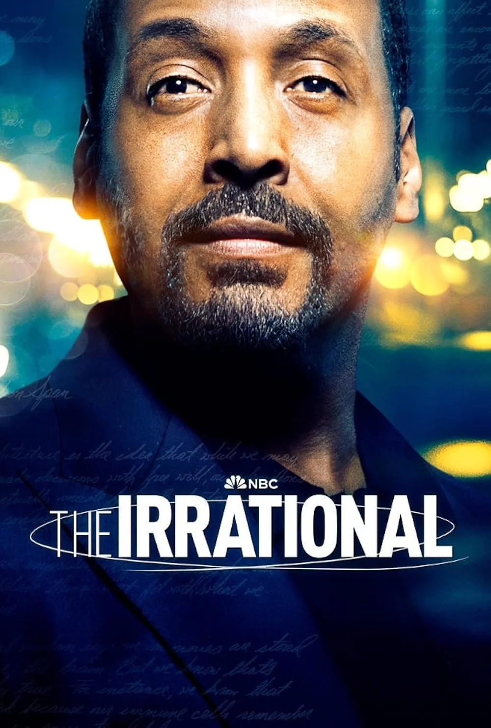 Close-up of a man's face with short hair, beard, and mustache, looking directly at the camera with a blurred city lights background. Text reads 'The Irrational' and NBC.