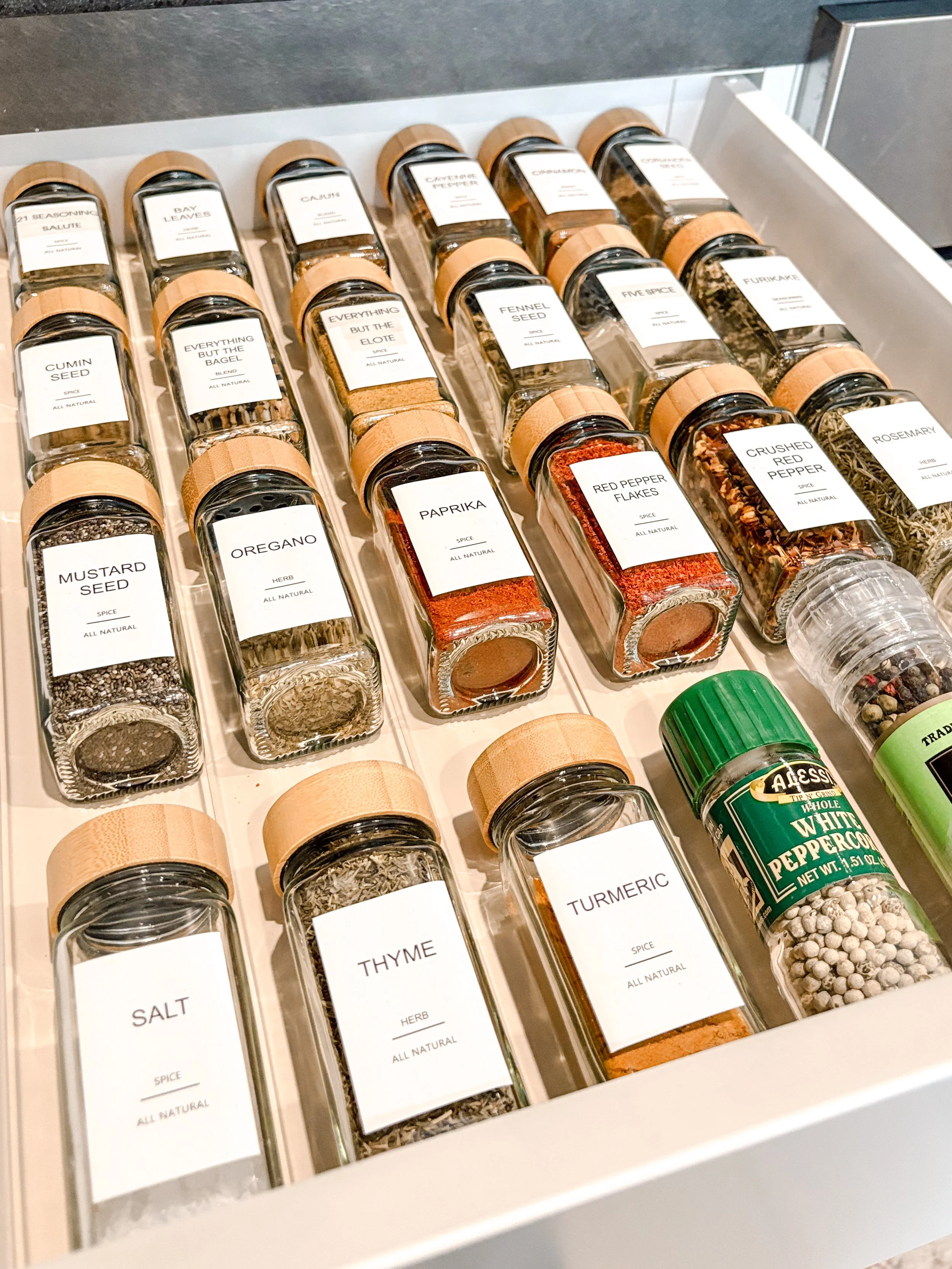 Organized spice drawer with neat jars and labels