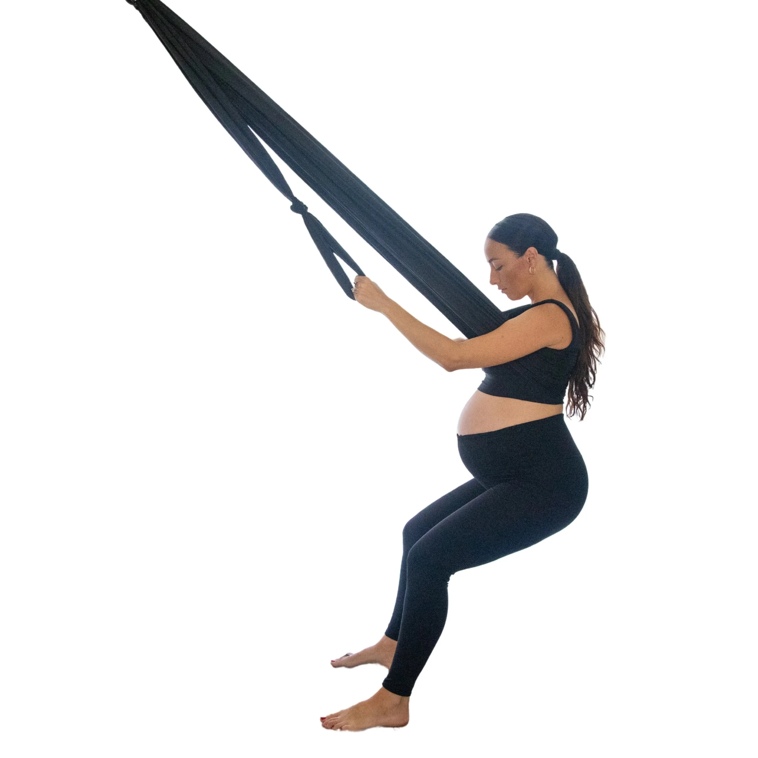 Scenic landscape of mountains, lake, and rolling green hills under cloudy sky.