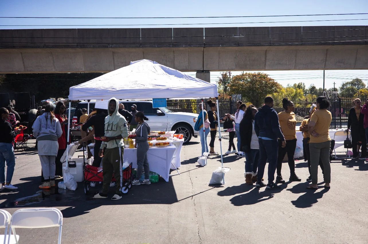 Outdoor gathering with people at a food tent