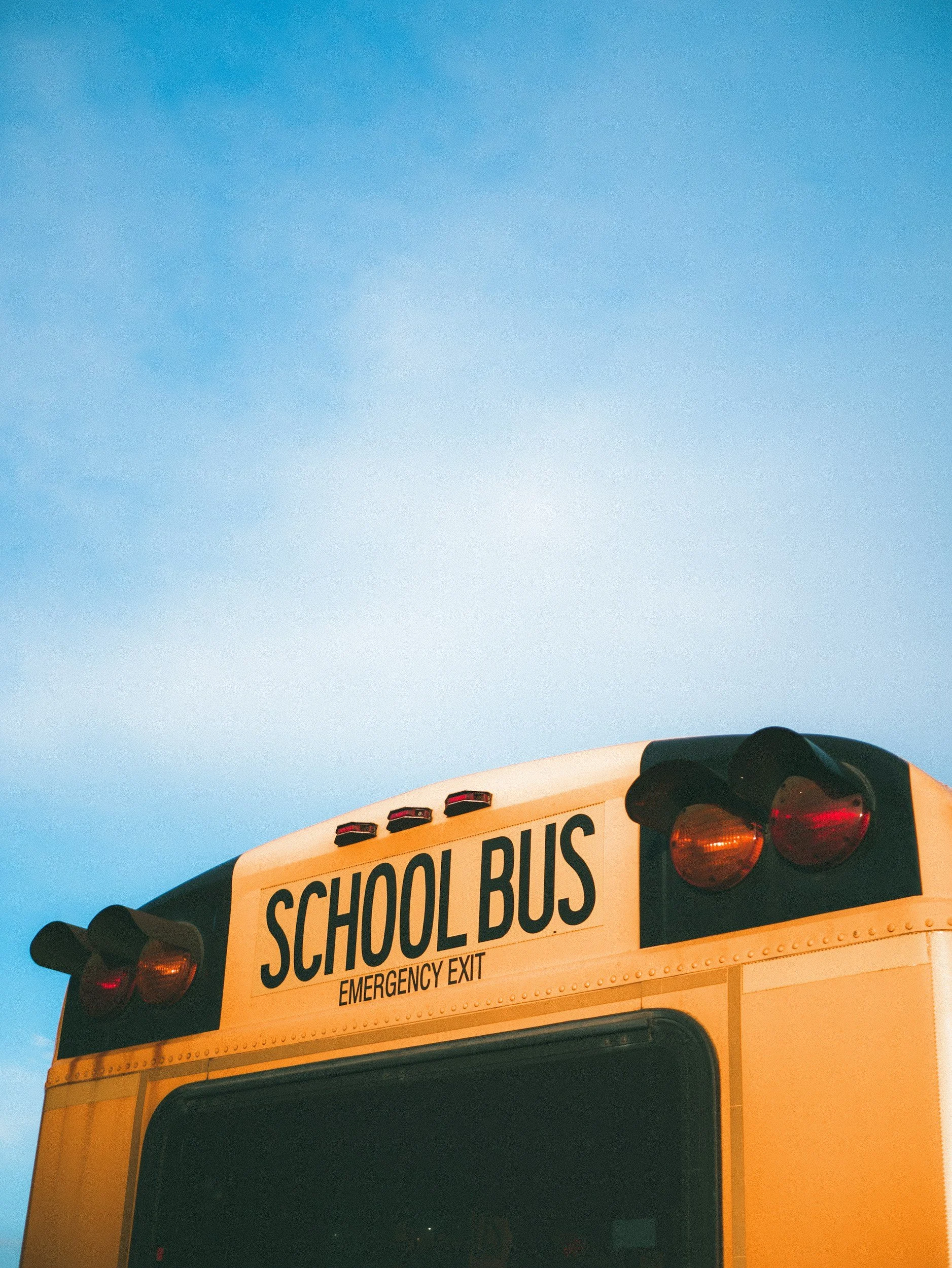 Photo of a school bus and blue sky.