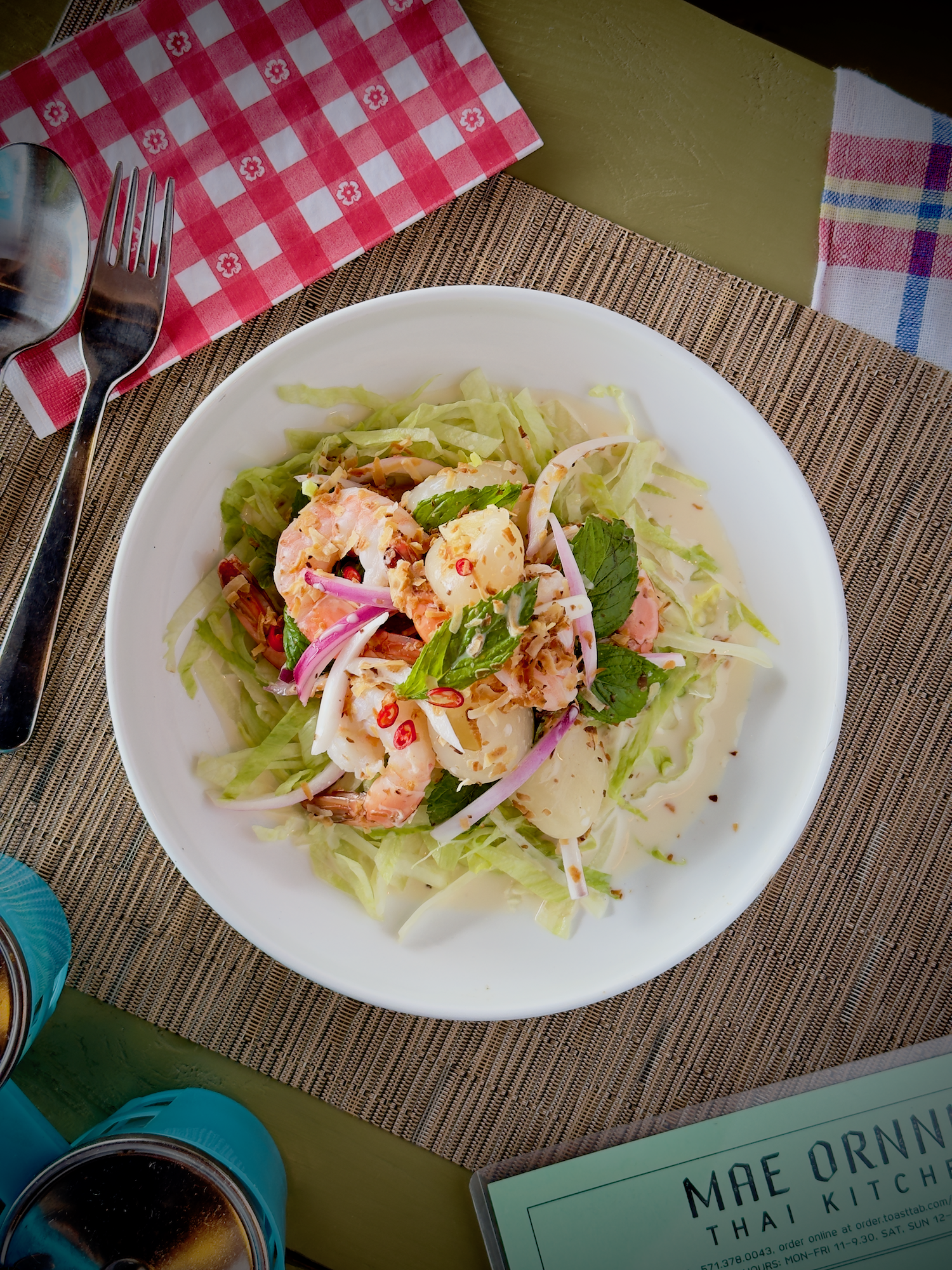 Top view of Mae Ornnit Salad - Tangy, Refreshing, Spice salad mixed with shrimp, rambutan, fresh chili, onion, mint, slice cabbage.