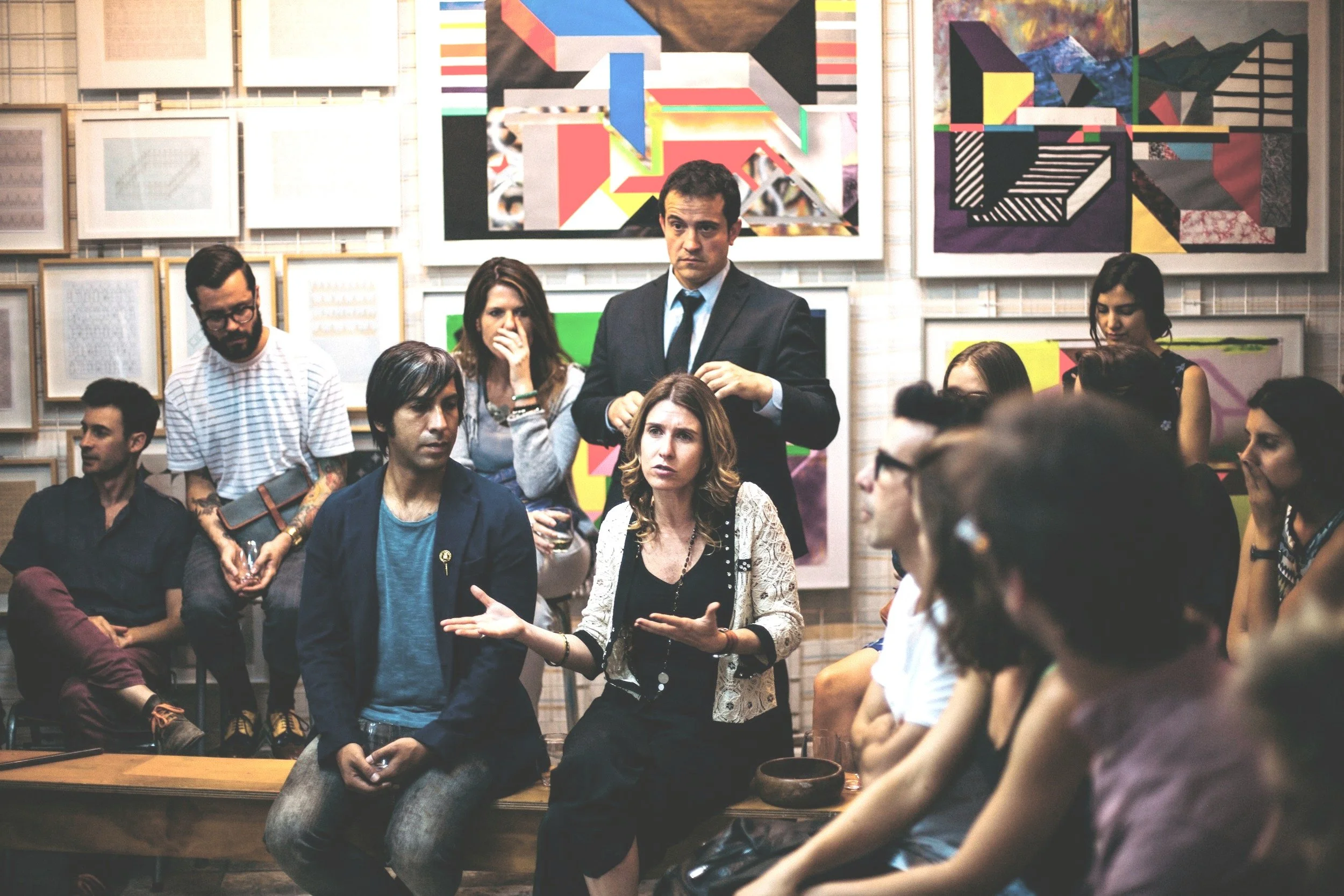 Image of a group of people listening to a female talk
