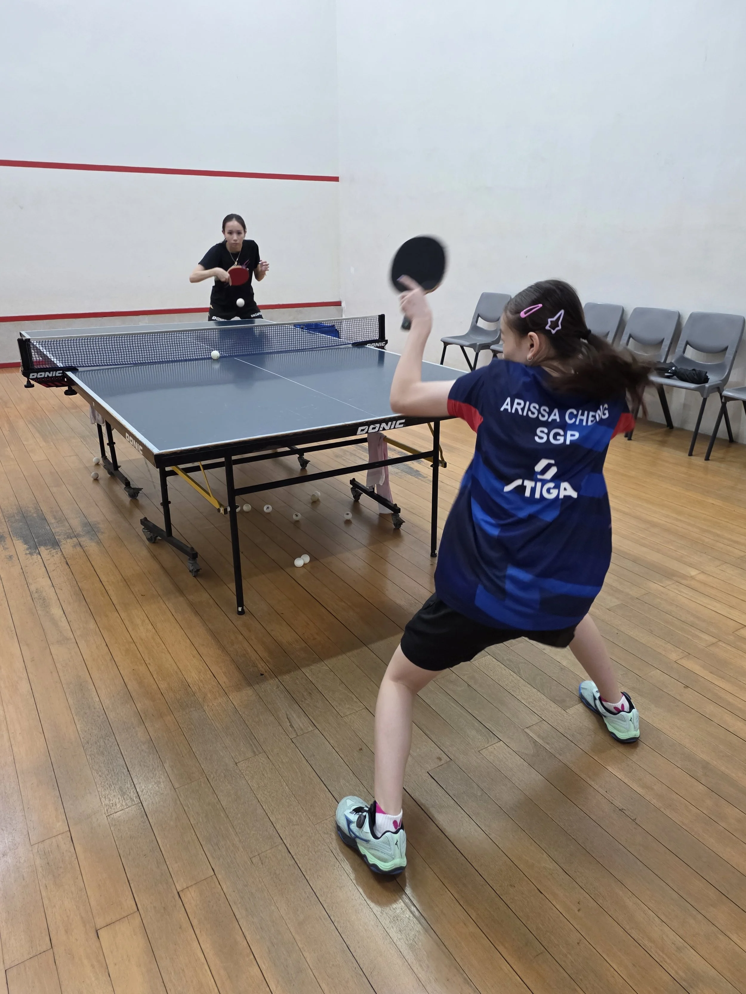 Coach Janissa providing private table tennis coaching to a developing player in Singapore