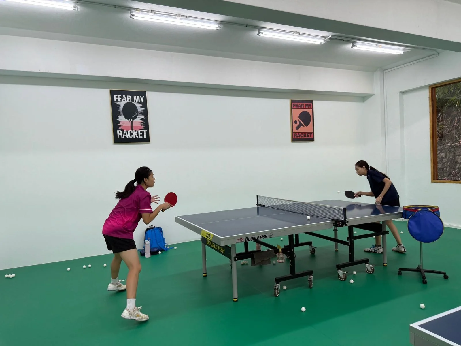 Two young players during a private 1-to-1 table tennis lesson in Singapore.