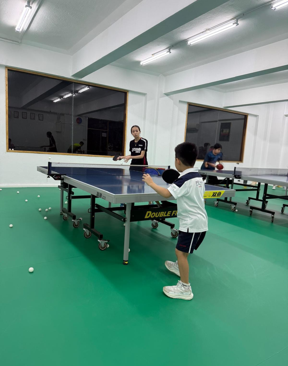 Coach Janissa providing private table tennis coaching to a junior player in Singapore