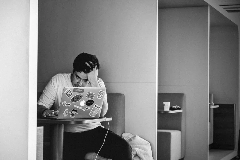 A new manager overwhelmed at their desk, representing the leadership gap that occurs when high performers are promoted without clarity or preparation