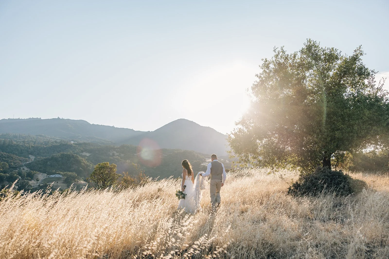 A newly married couple strolling the open expanses of Red Barn Ranch